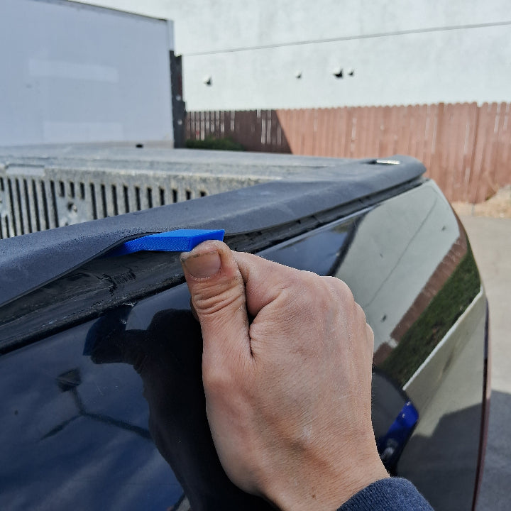 Panel clip tool being used to gain access to truck bed panel clips
