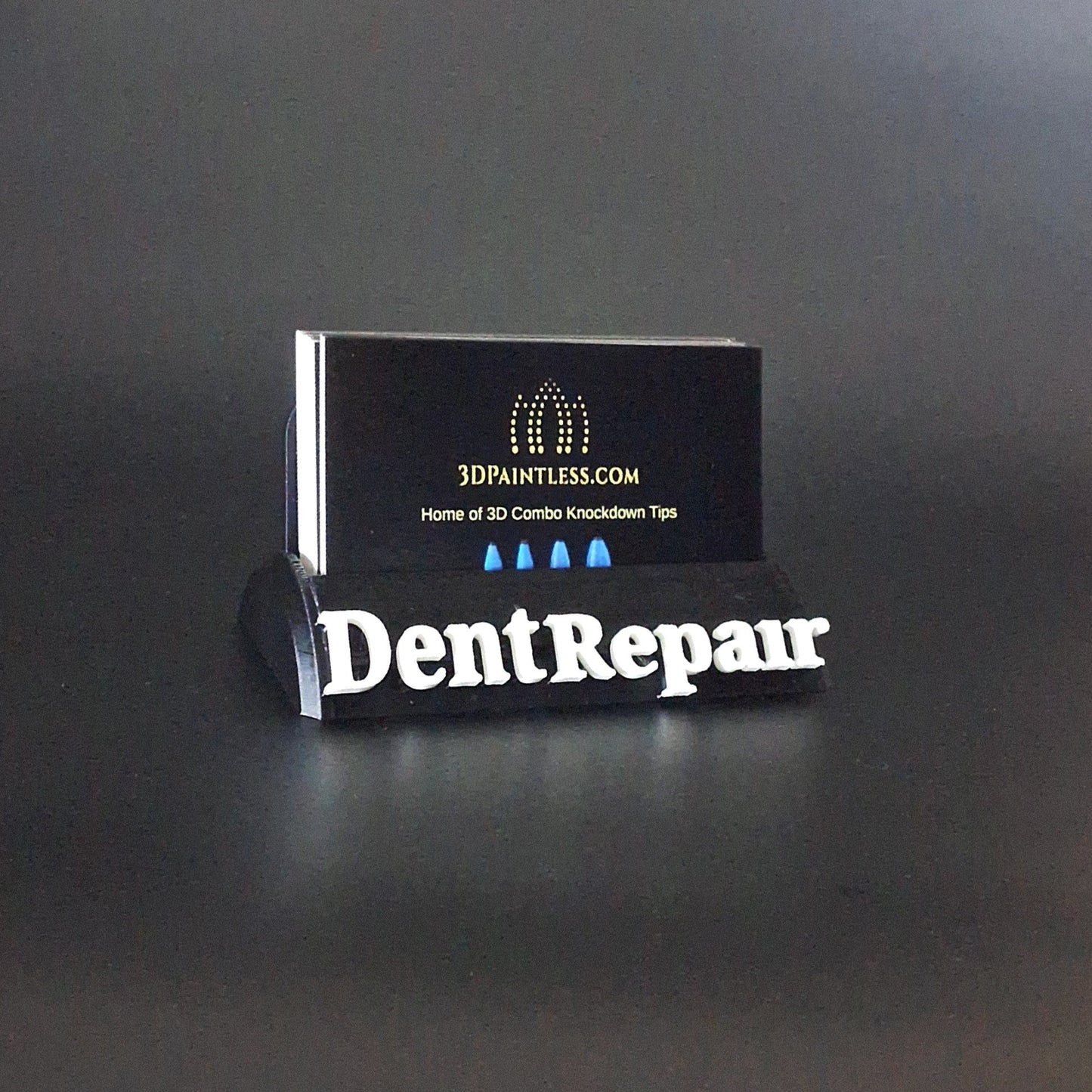 A business card holder advertising a paintless dent repair company.