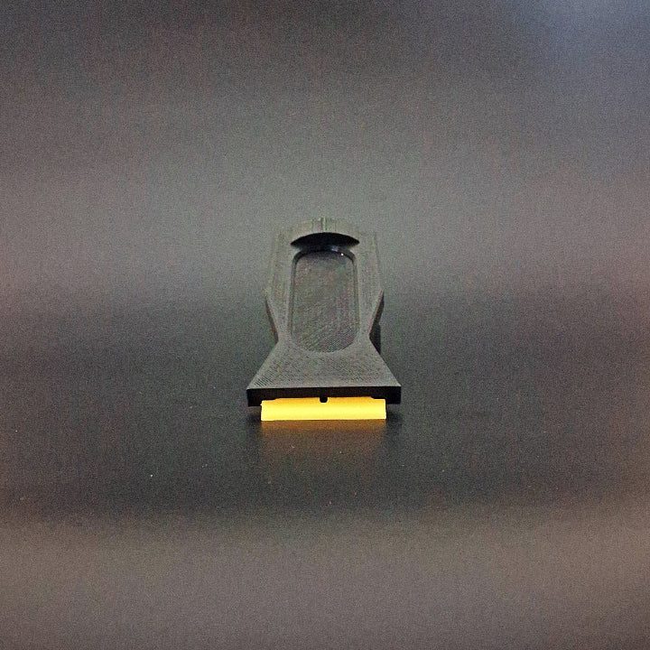 A plastic razor scraper for removing PDR glue photographed from the front