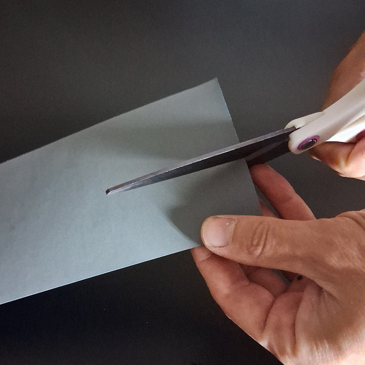 Cutting sandpaper so that it fits in the Sanding Block Small