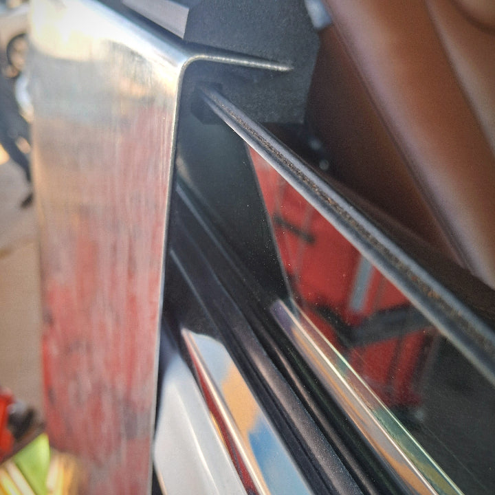 A window guard inserted into a car door that has laminated glass